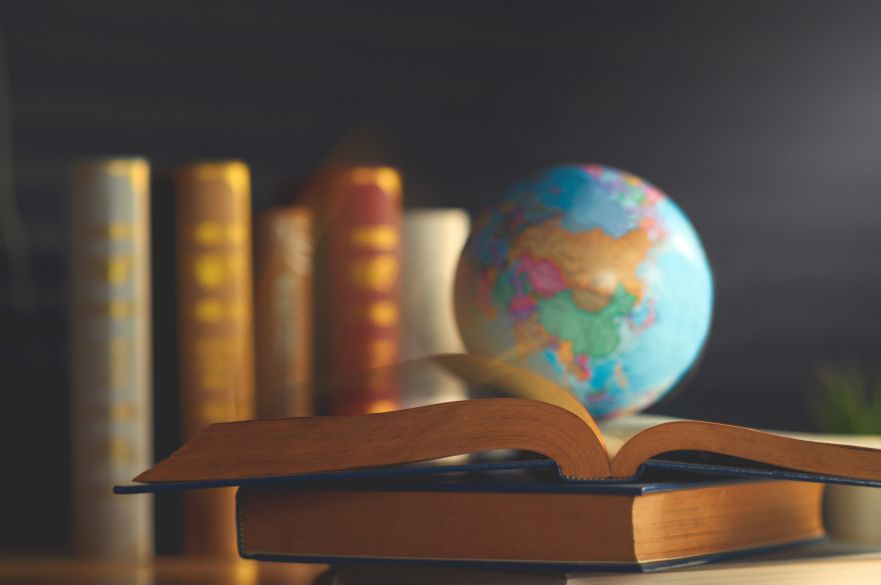Globe sitting on top of open books