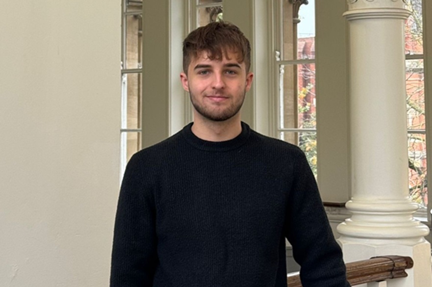 A person smiling, posed to have their picture taken.