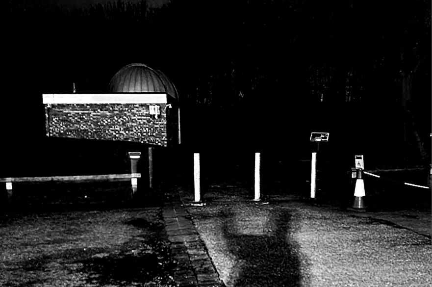 Black and white image of the NTU observatory with shadow of person