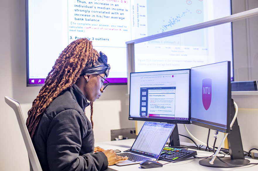 A student working in the lab on her laptop.