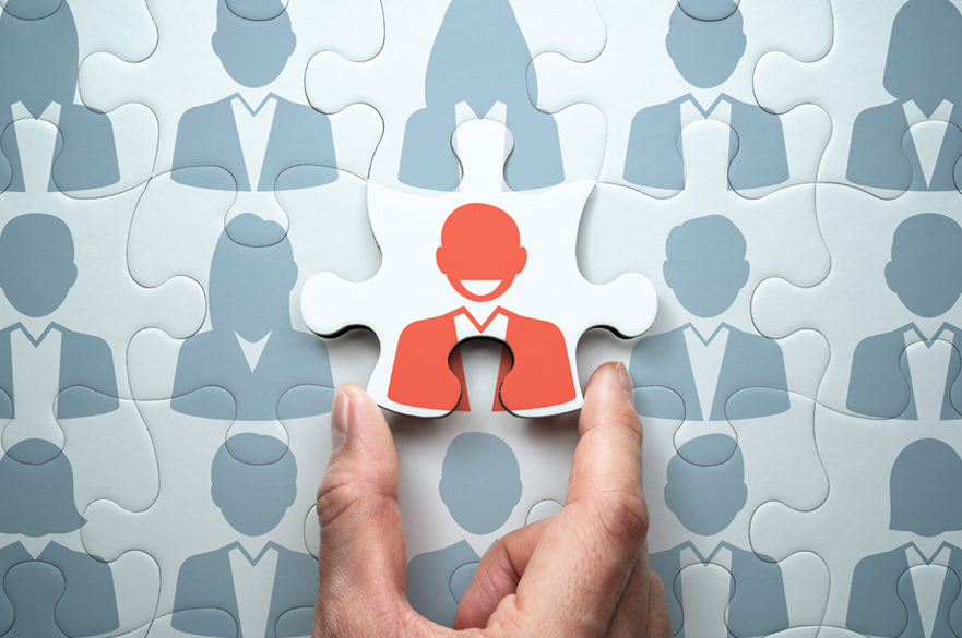Leader connecting the last jigsaw puzzle piece