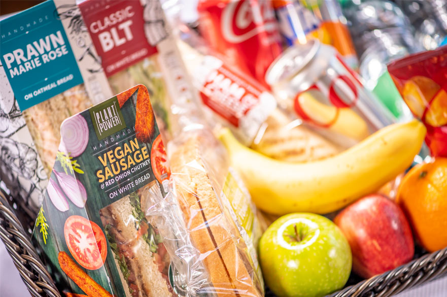 An assortment of sandwiches, fruits and snacks