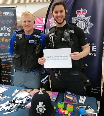 Members of the University Police team at a stand during an induction event.