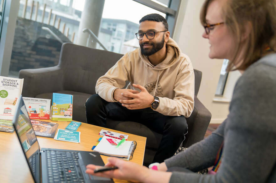 Student booking accommodation on laptop