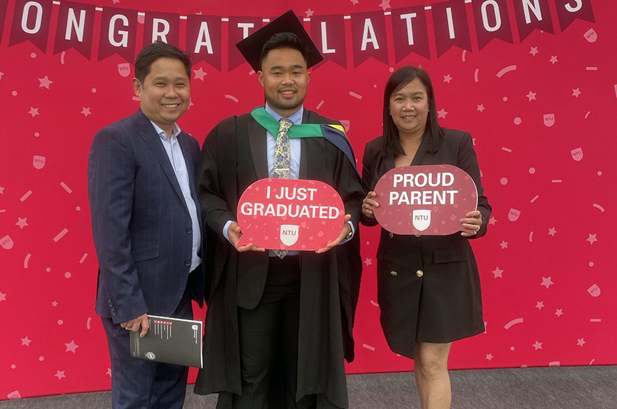 Sean Balagot with his proud parents during graduation