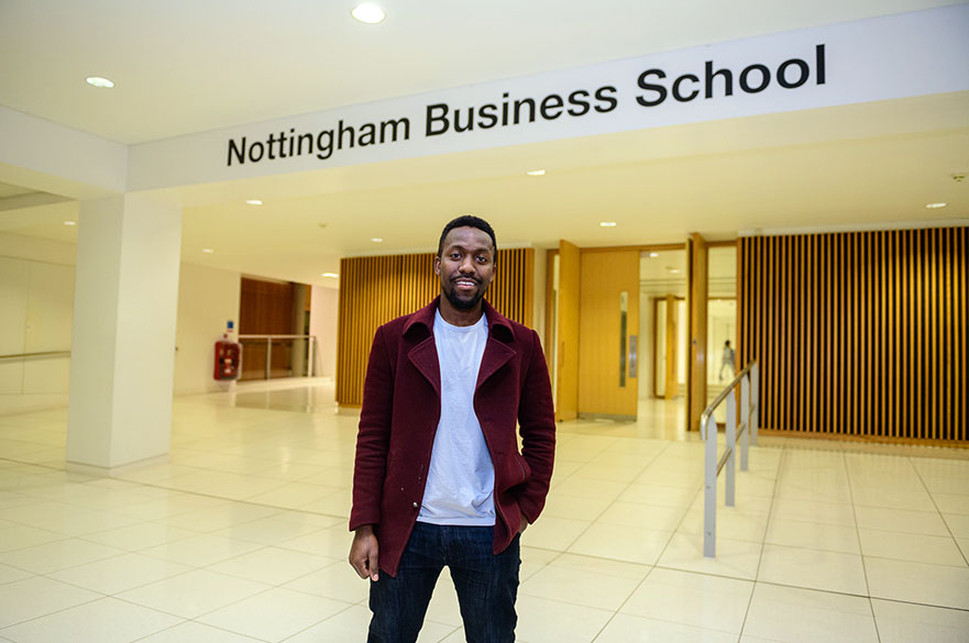 Wezi Munkhondya standing outside the entrance to Nottingham Business School.