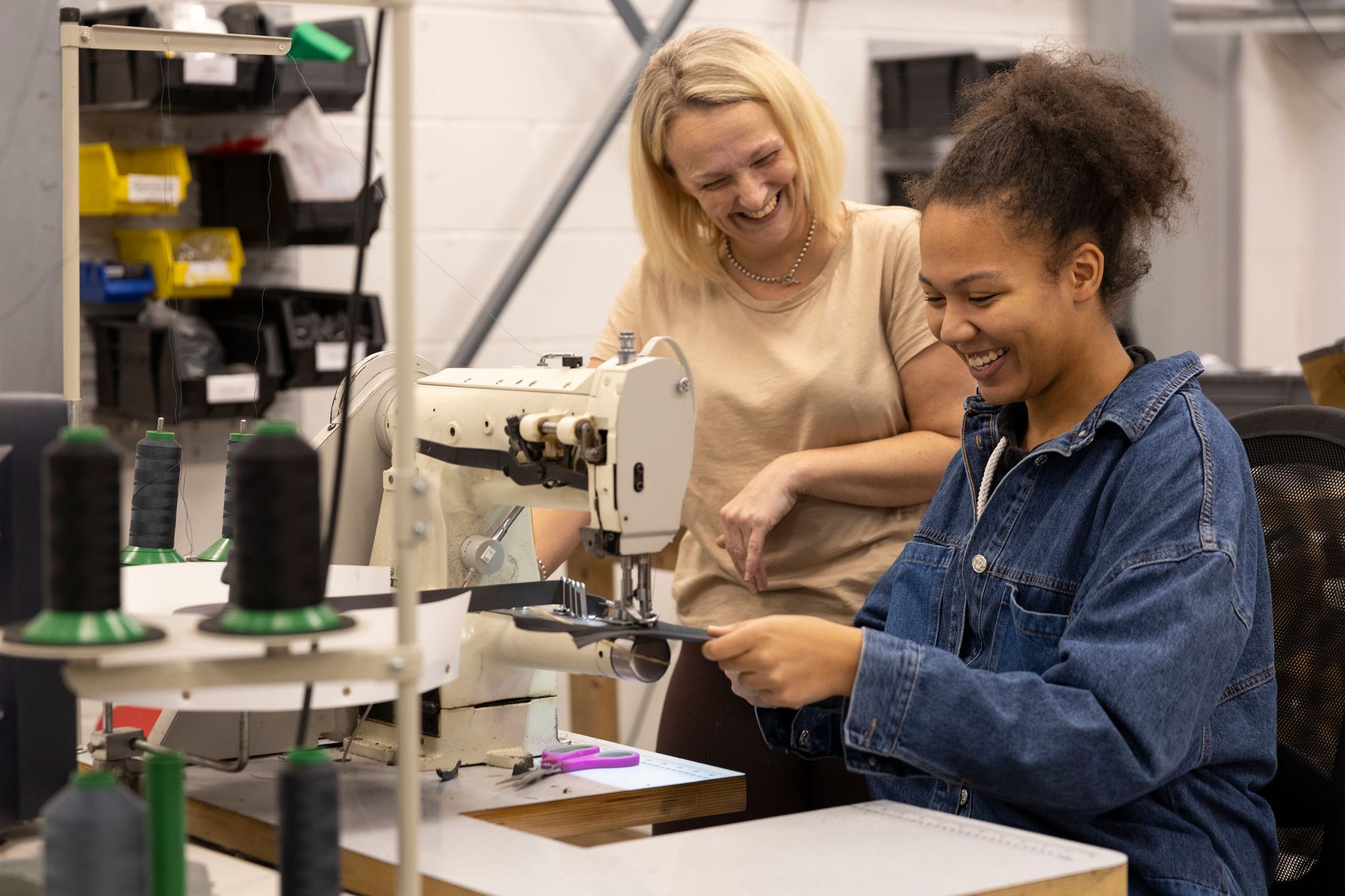 Two people by a sewing machine