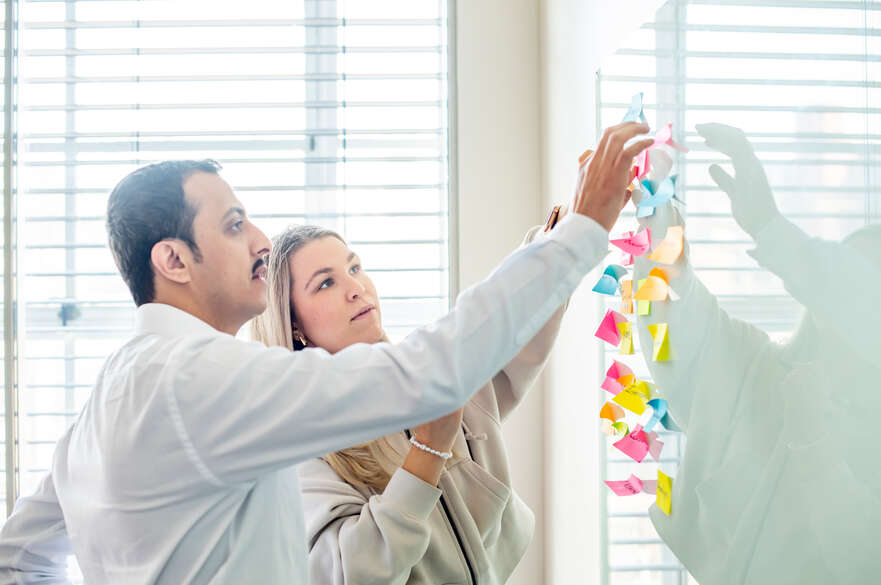 Male and female with sticky notes