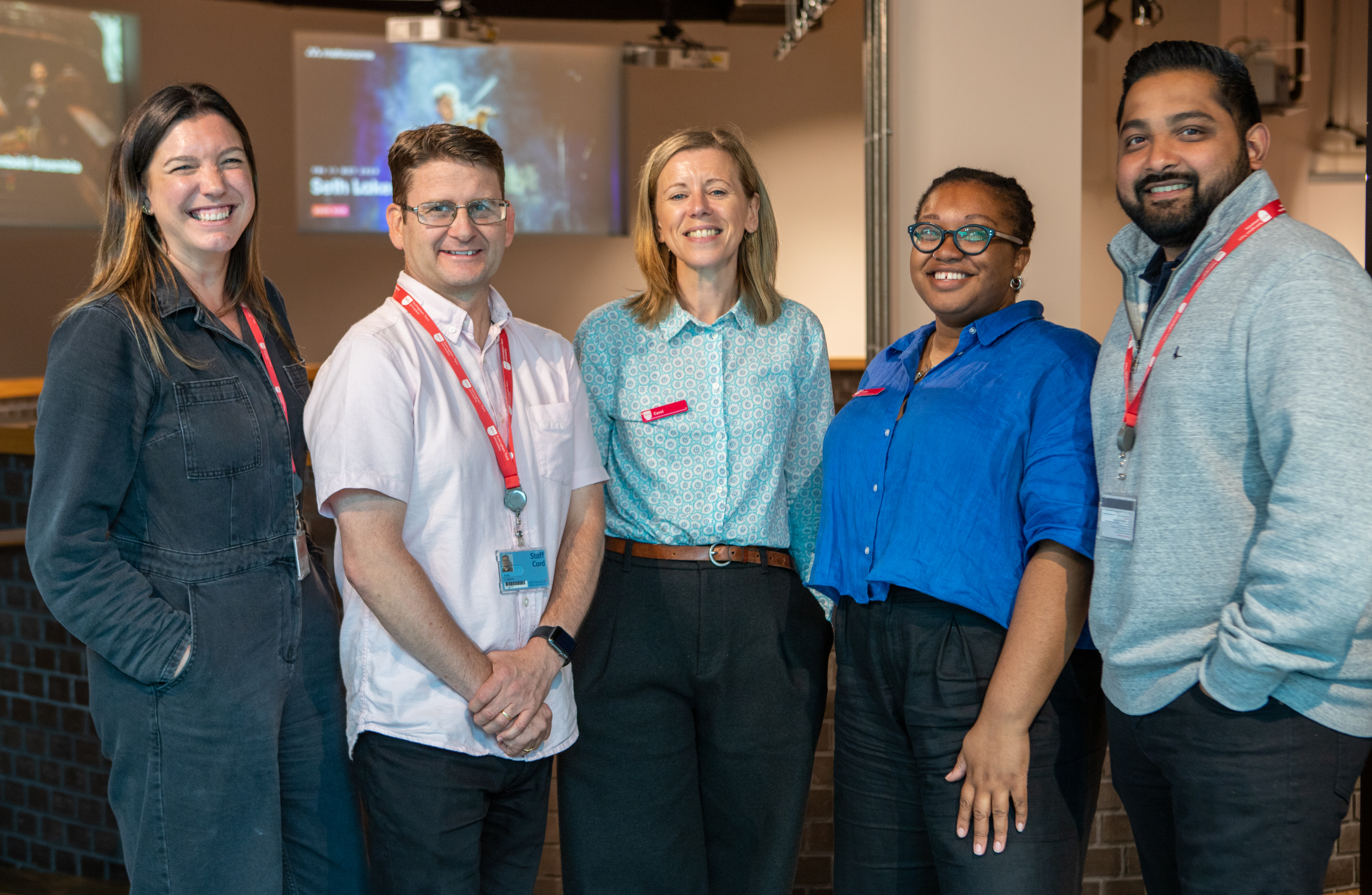 A photo of the Community Engagement and Volunteering Team. From left to right the image features Hannah Charlton, Andy Coppins, Carol Wilby, Safiya Williams and Adi Shah.