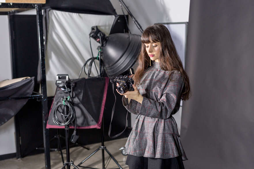 Photography student preparing their camera in a Bonington studio room