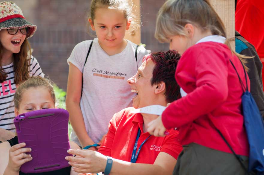 smiling teacher with school aged children