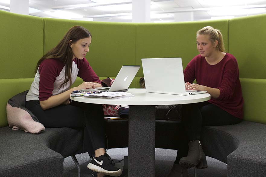 Girls on laptops in Library