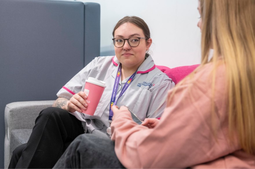 Nursing student sat on sofa