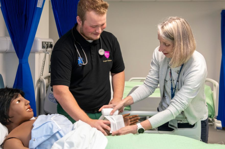 Abulance Technician Practice student and tutor on mock hospital ward