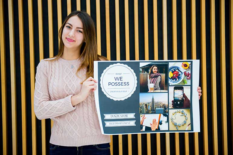 Student holding poster