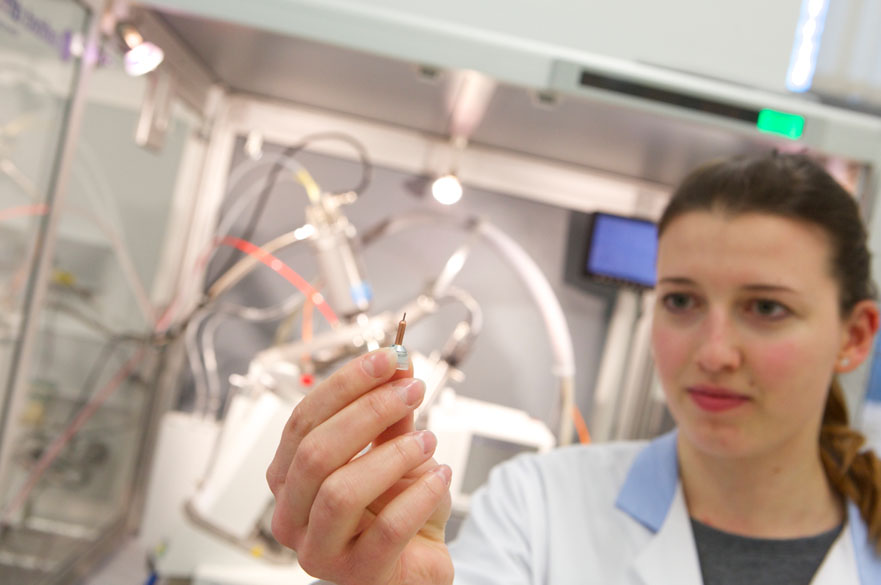 Student holding scientific equipment