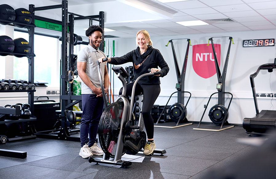 Sport and Wellbeing Participant on Bike with Coach