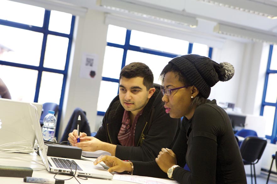 2 students using laptop