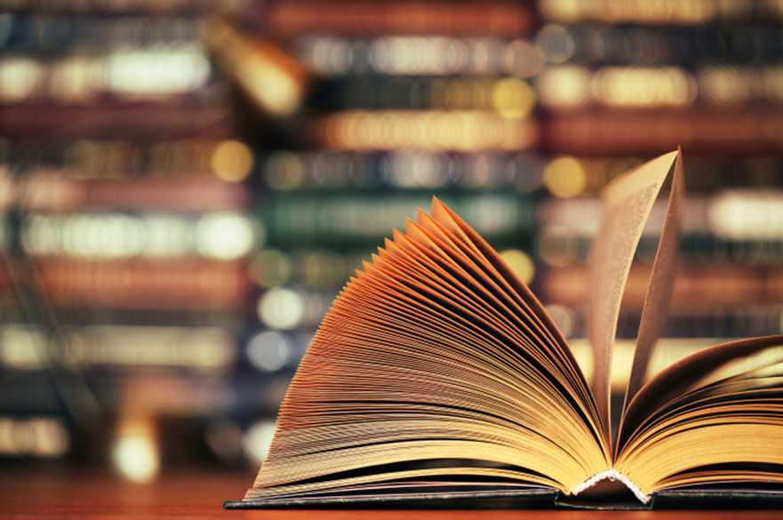 A book laid on its spine with the pages fanned out.