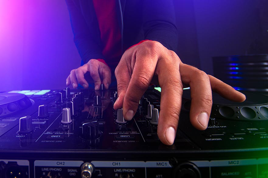 A close up of hands operating a mixer.