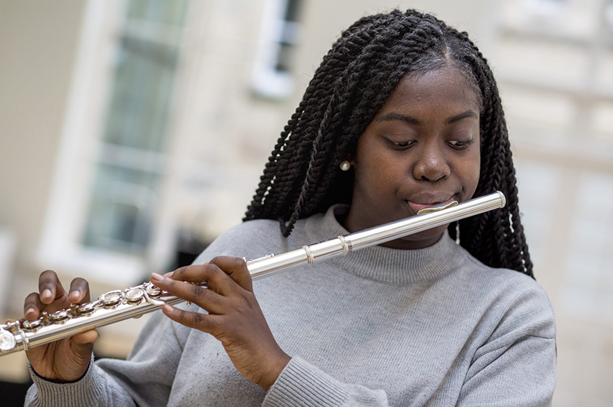 A girl playing a flute.