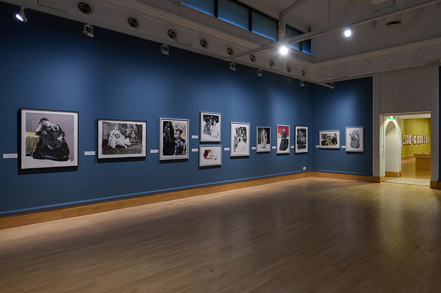 An art gallery with pictures on the wall.