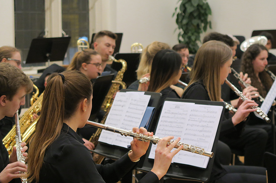The NTU Concert Band playing flutes, saxophones and oboes.