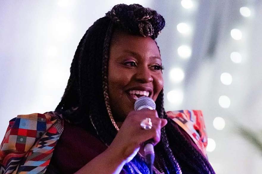 A female singing into a microphone.