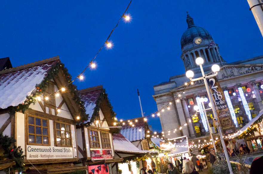 Nottingham city centre Christmas market with council house in the background.