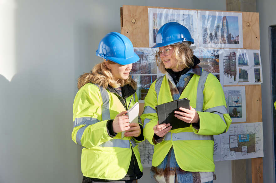 Two females in high vis on construction site
