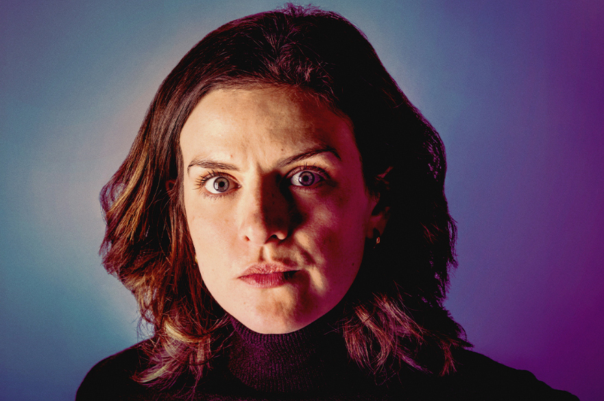 A woman looking intense wearing a black polo neck, and the words Girls & Boys written.