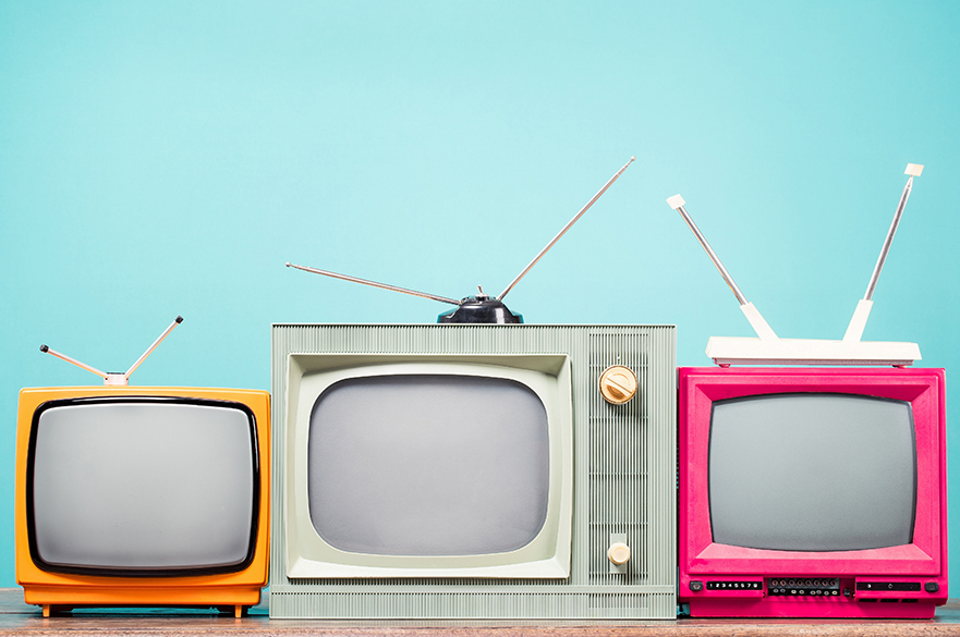 Three brightly coloured retro TV sets.