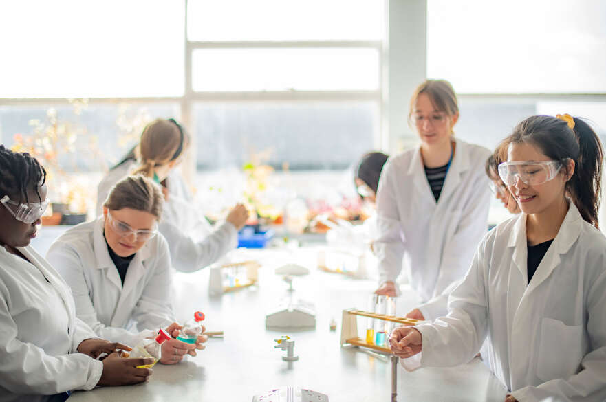 Students with science lab equipment 