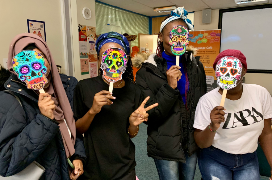 group of students wearing handmade dia de los muertos masks
