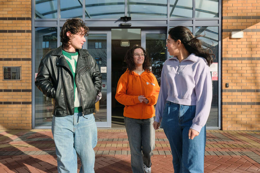 three global lounge ambassadors walking out of mary ann evans building in clifton campus
