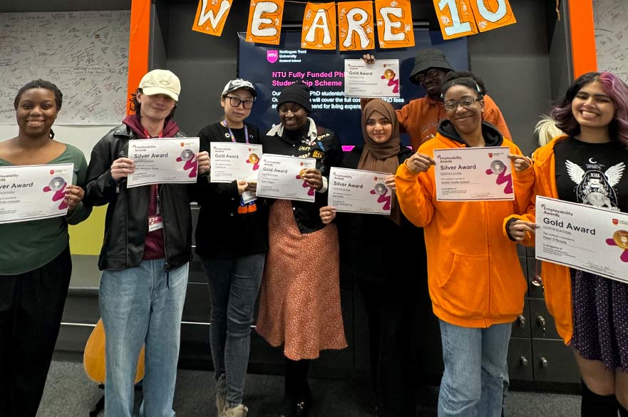 group of diverse students holding their employability award certificates in city global lounge