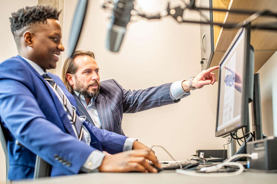People looking at a computer