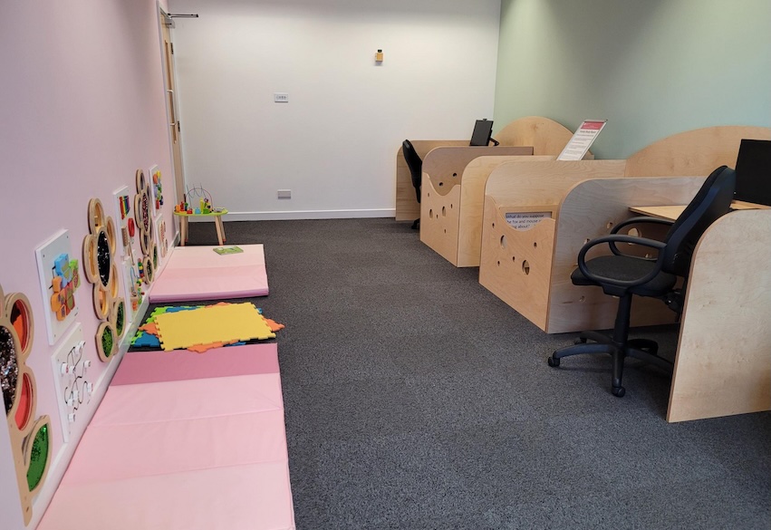 Family Study Room in Boots Library with a play area for children and desks, chairs and computers.