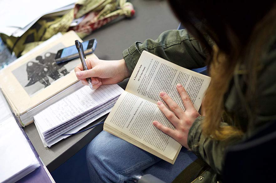 Student writing in notebook