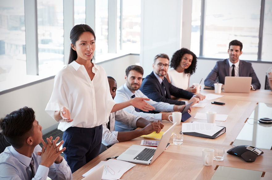 Lady presenting in a boardroom meeting.