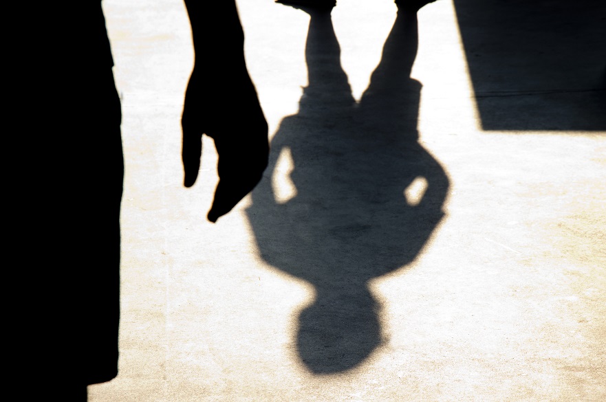 Shadows of a woman and man on the ground