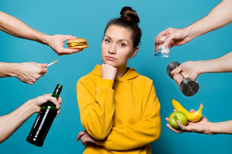 A girl reflects on a choice while healthy and not healthy things are offered to her from different sides