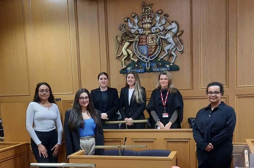 Participants stood in the NLS courtroom