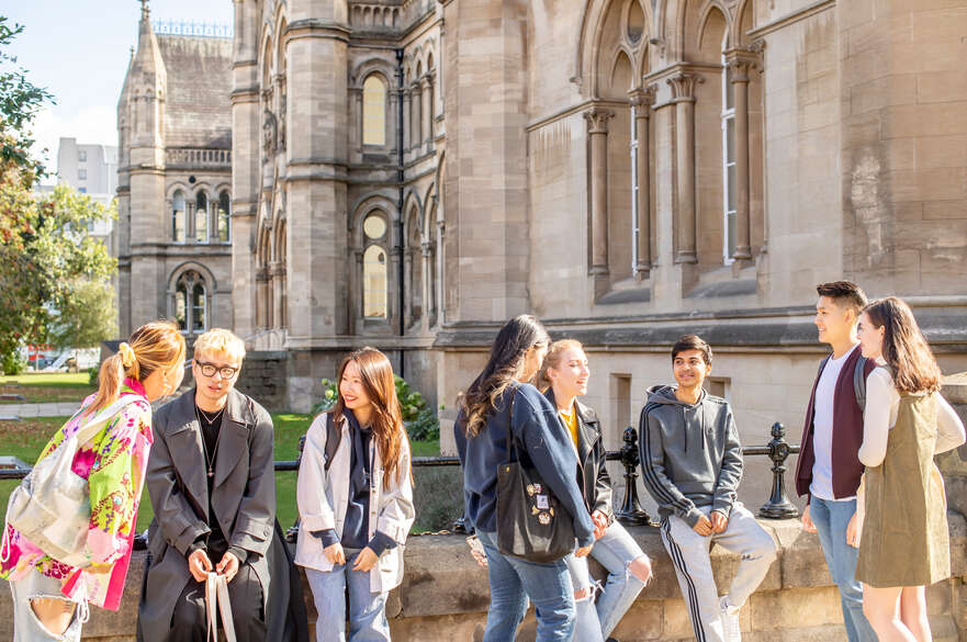 Students in front of a building, talking