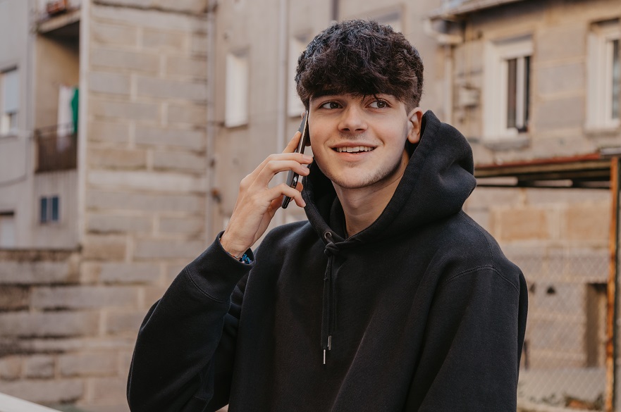 Teenager talking on mobile phone in the street