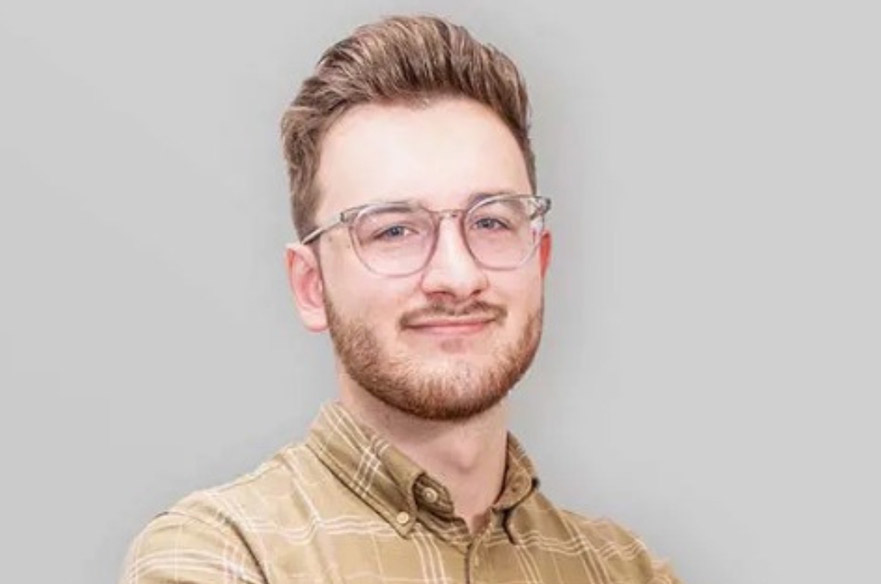 George smiling at the camera