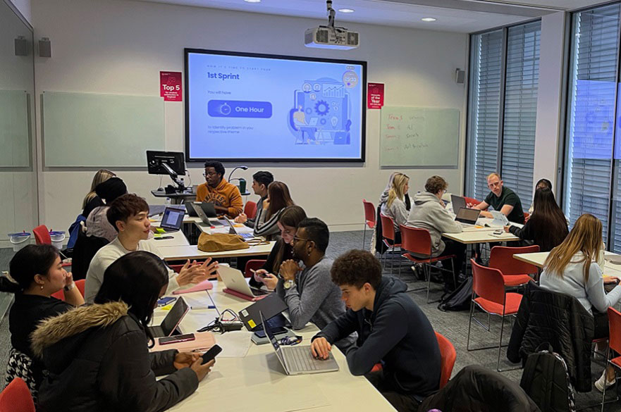 Students working in groups in a seminar room