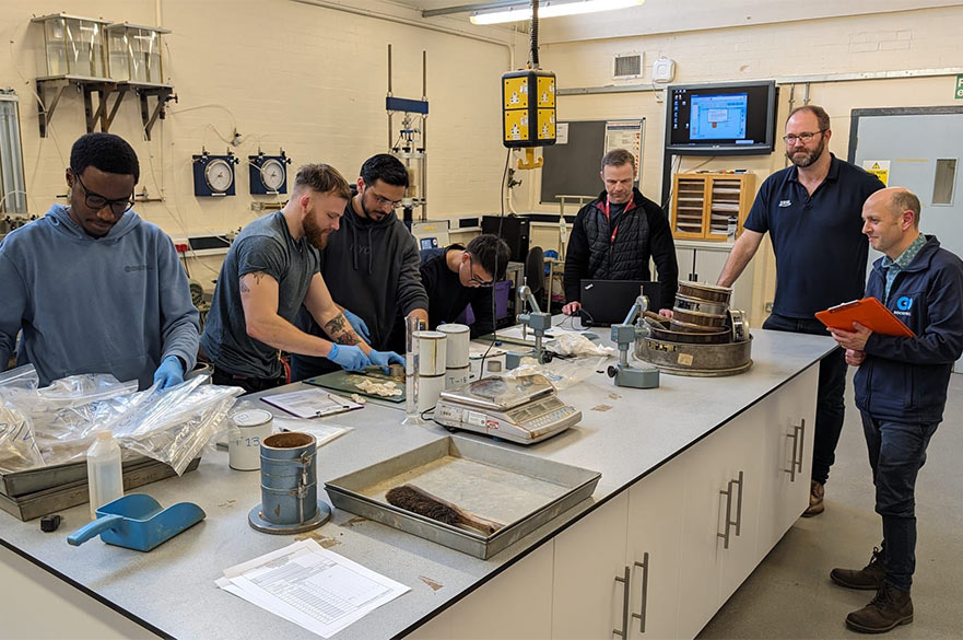 Students and academics working together inside of NTU's Geotechnical lab.