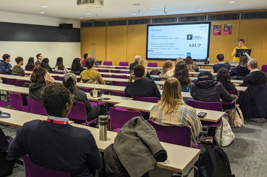 Event guests sat in the a seminar room watching a presentation on a projector