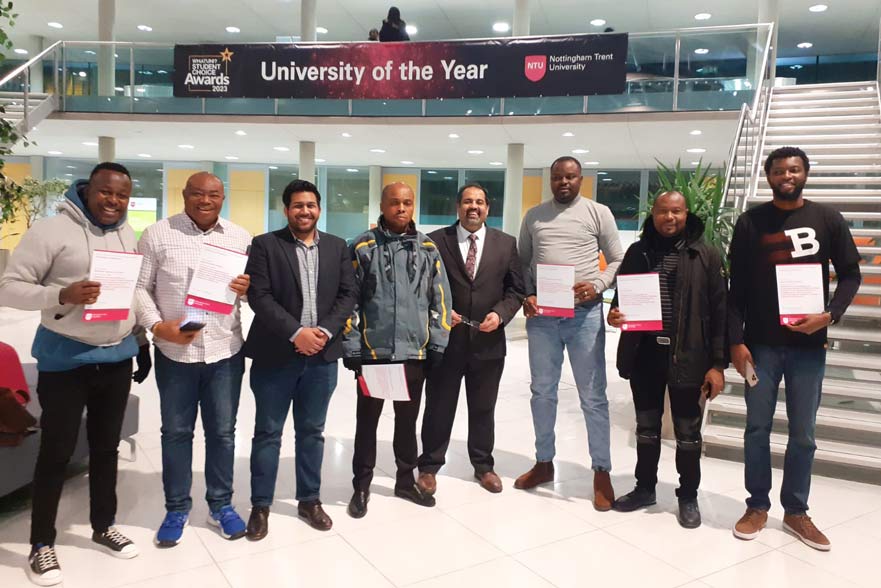 The delegation of Nigeria posing for a picture holding their certificates in the Newton building lobby